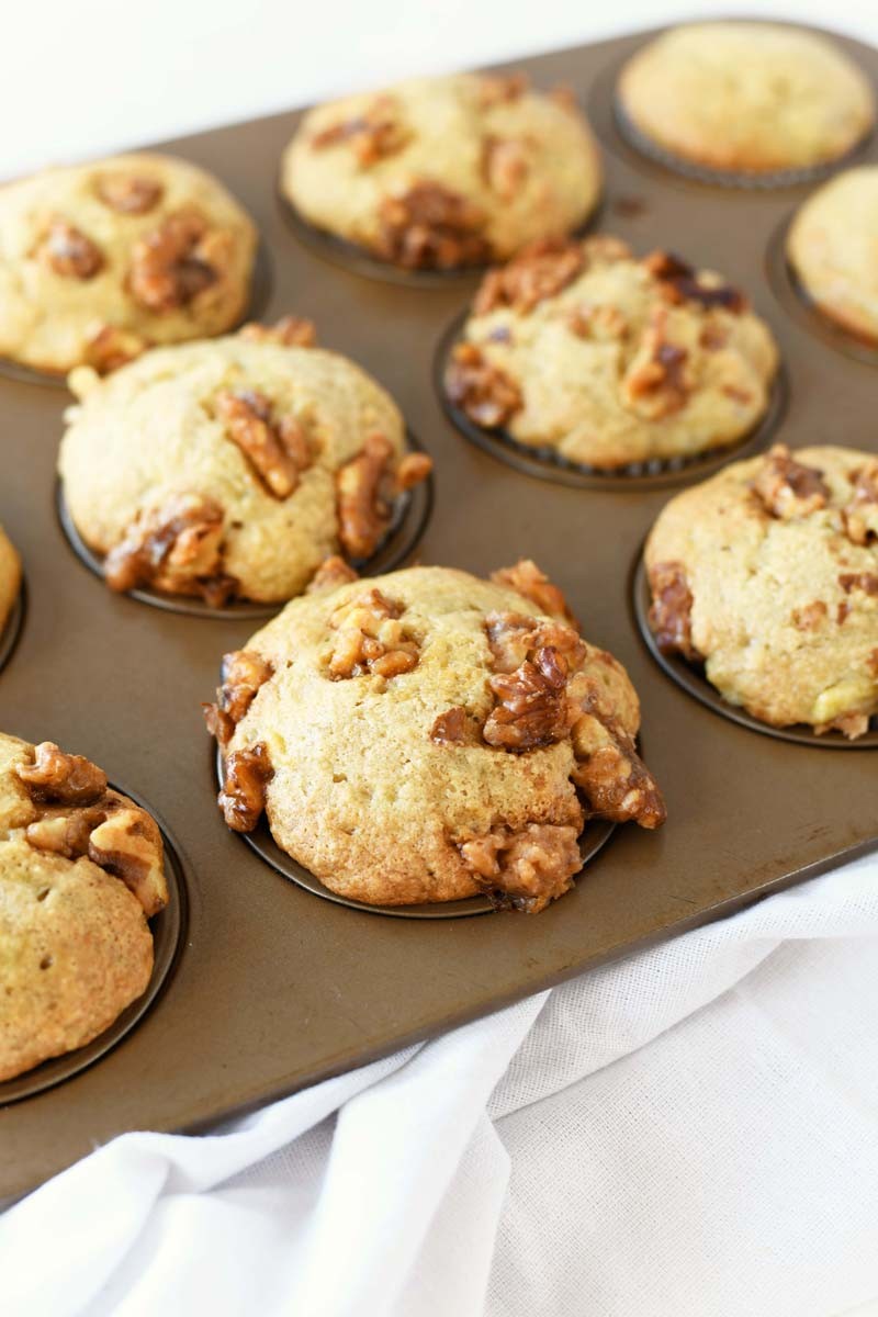 Candied Walnuts Banana Muffins in a gold muffin tin baked.