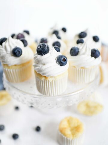 WW cupcakes recipe. Angel food cupcakes on a stand with whipped topping and fresh blueberries.