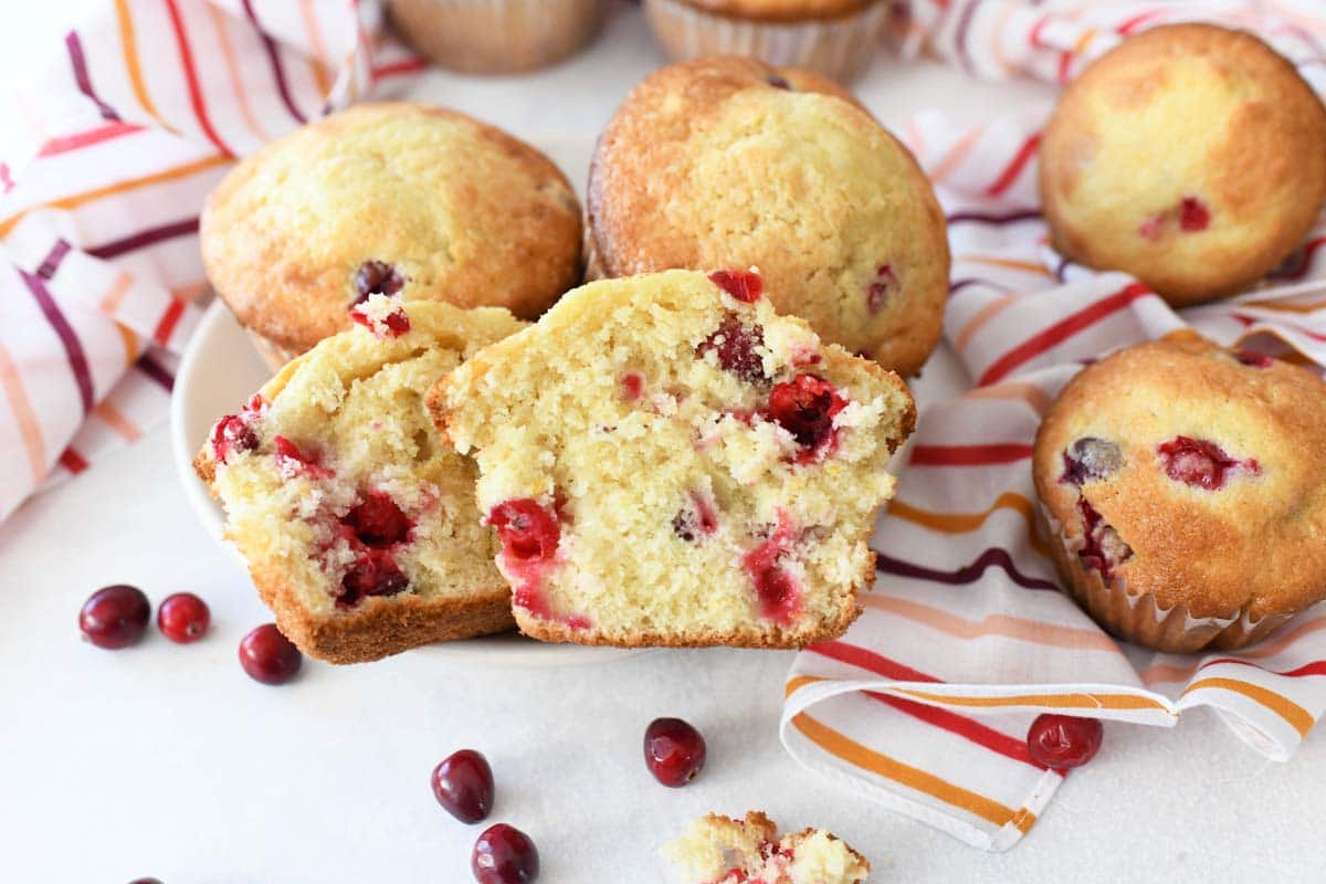 Cranberry Orange Jumbo Muffins with a striped napkin and whole cranberries.