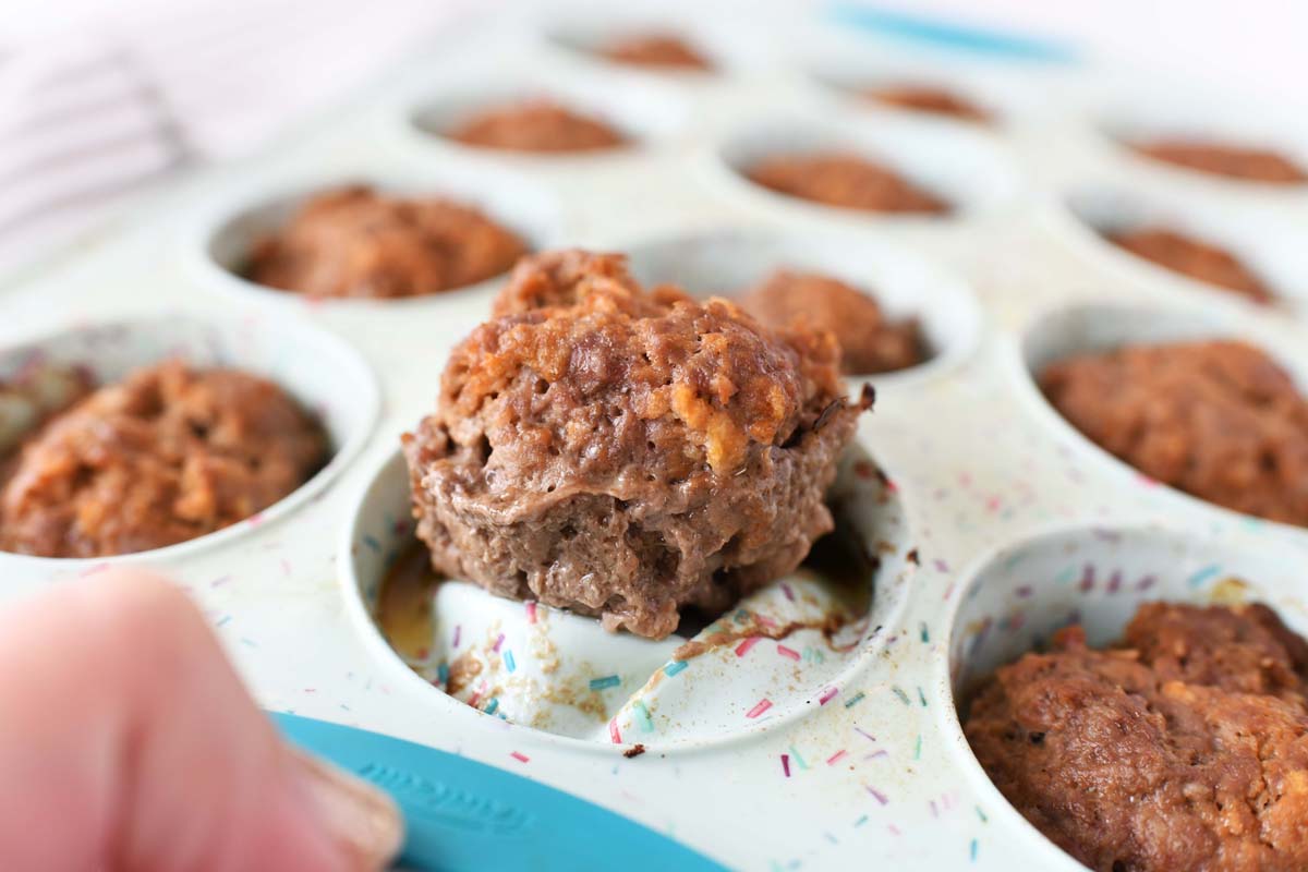 Meatloaf in a muffin pan. A mini meatloaf is being popped out of a blue sprinkle muffin pan. 