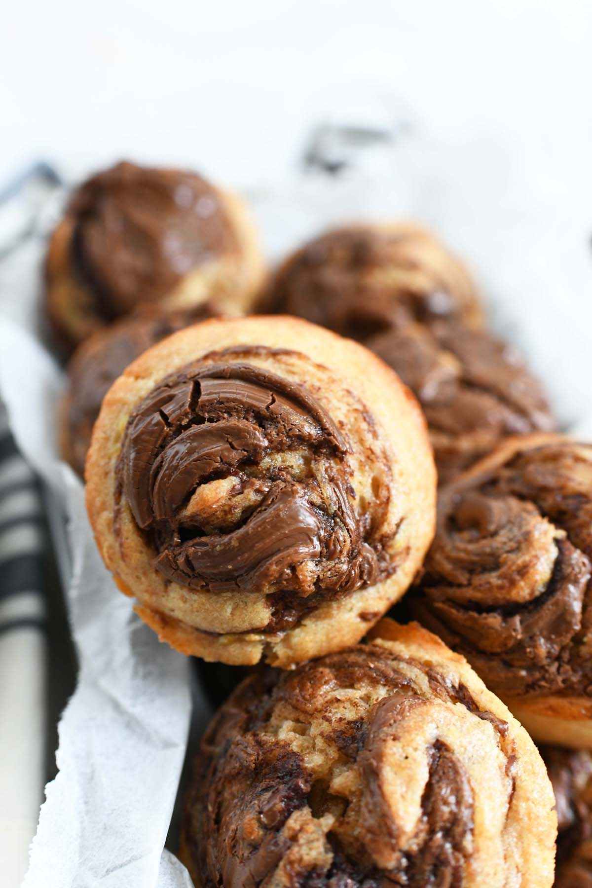 Nutella Swirled Banana Muffins up close. There is a pretty brown Nutella swirl on these banana muffins.