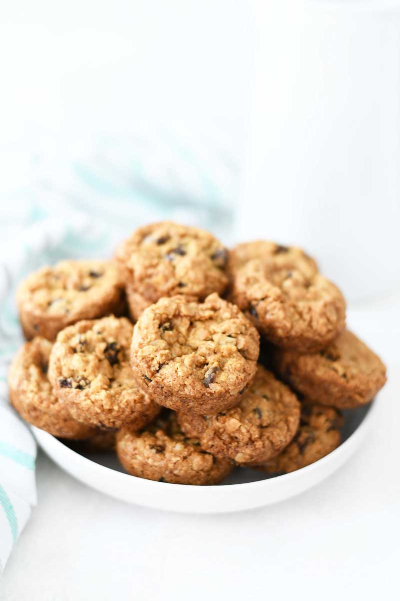 Golden Brown Oatmeal Raisin cookies in a white dish. 