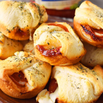 Pepperoni Crescent Bites re on a wooden plater.