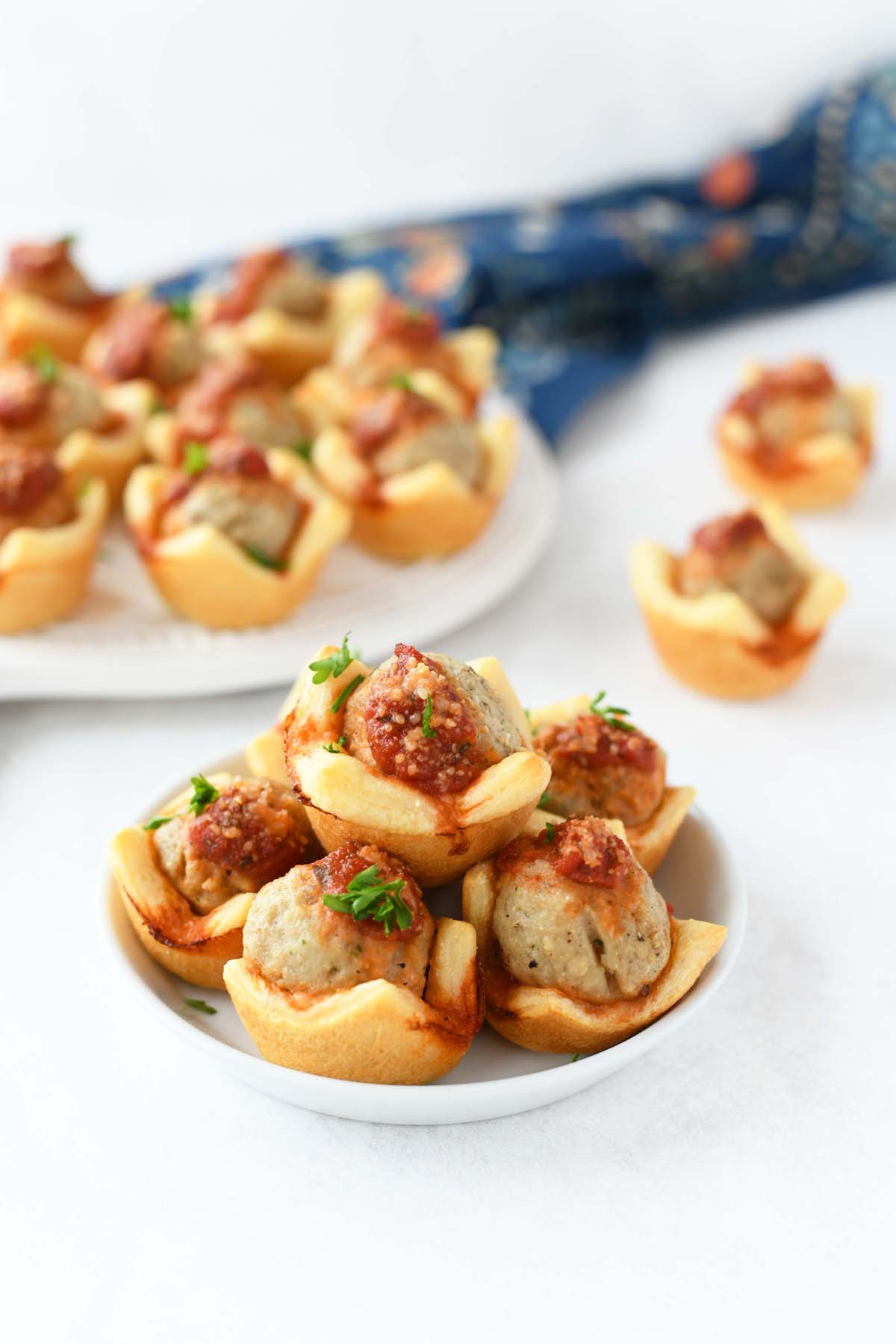 Meatball Crescent cupcake bites on a small white plate.