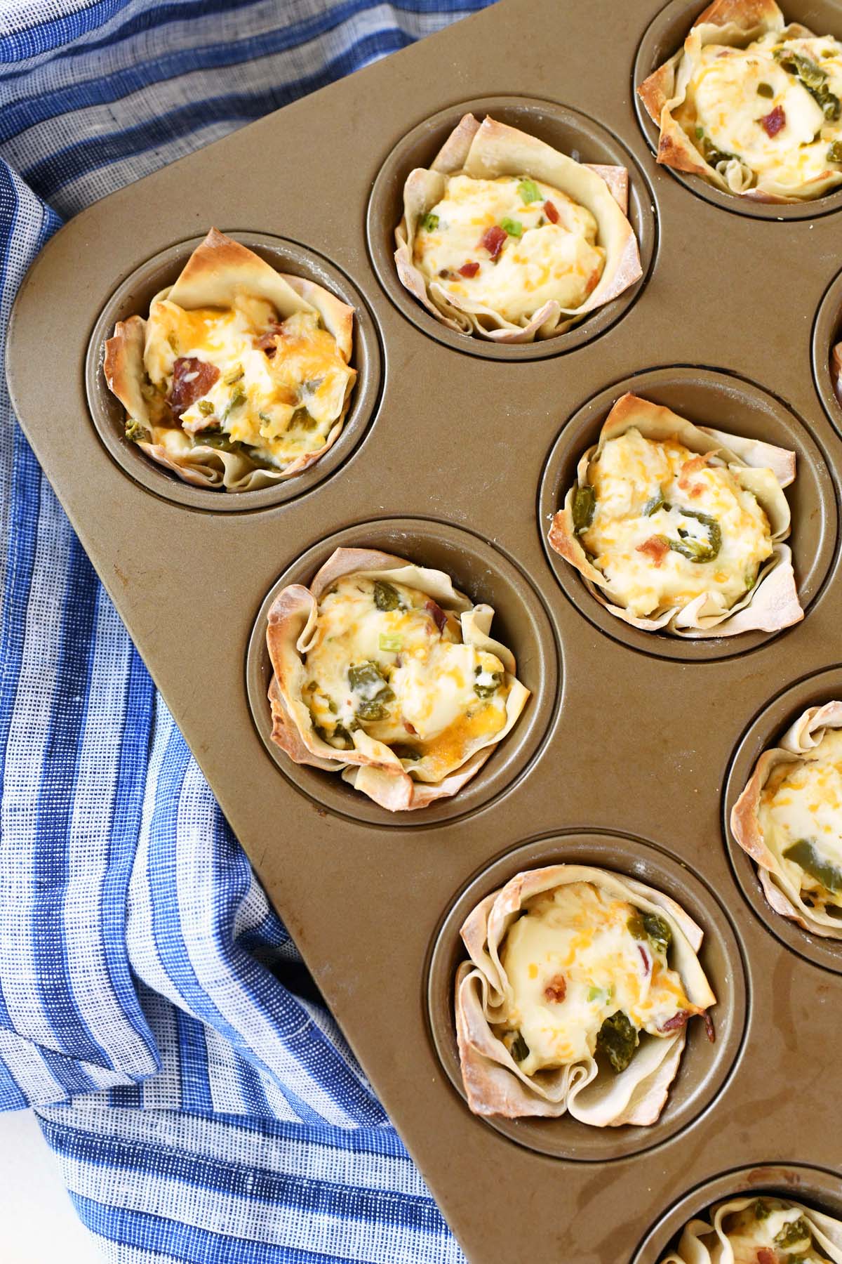Jalapeno Wonton Cups in a gold muffin tin.