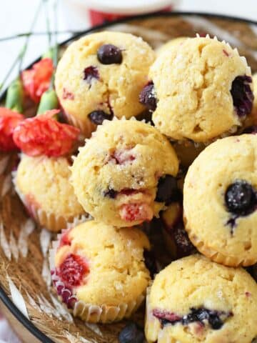 Up close shot of triple berry cottage cheese muffins in a basket.