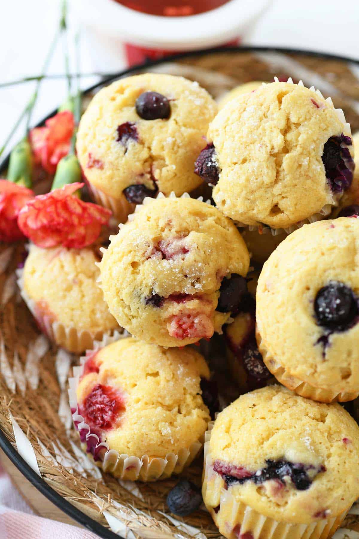 Up close shot of triple berry cottage cheese muffins in a basket.