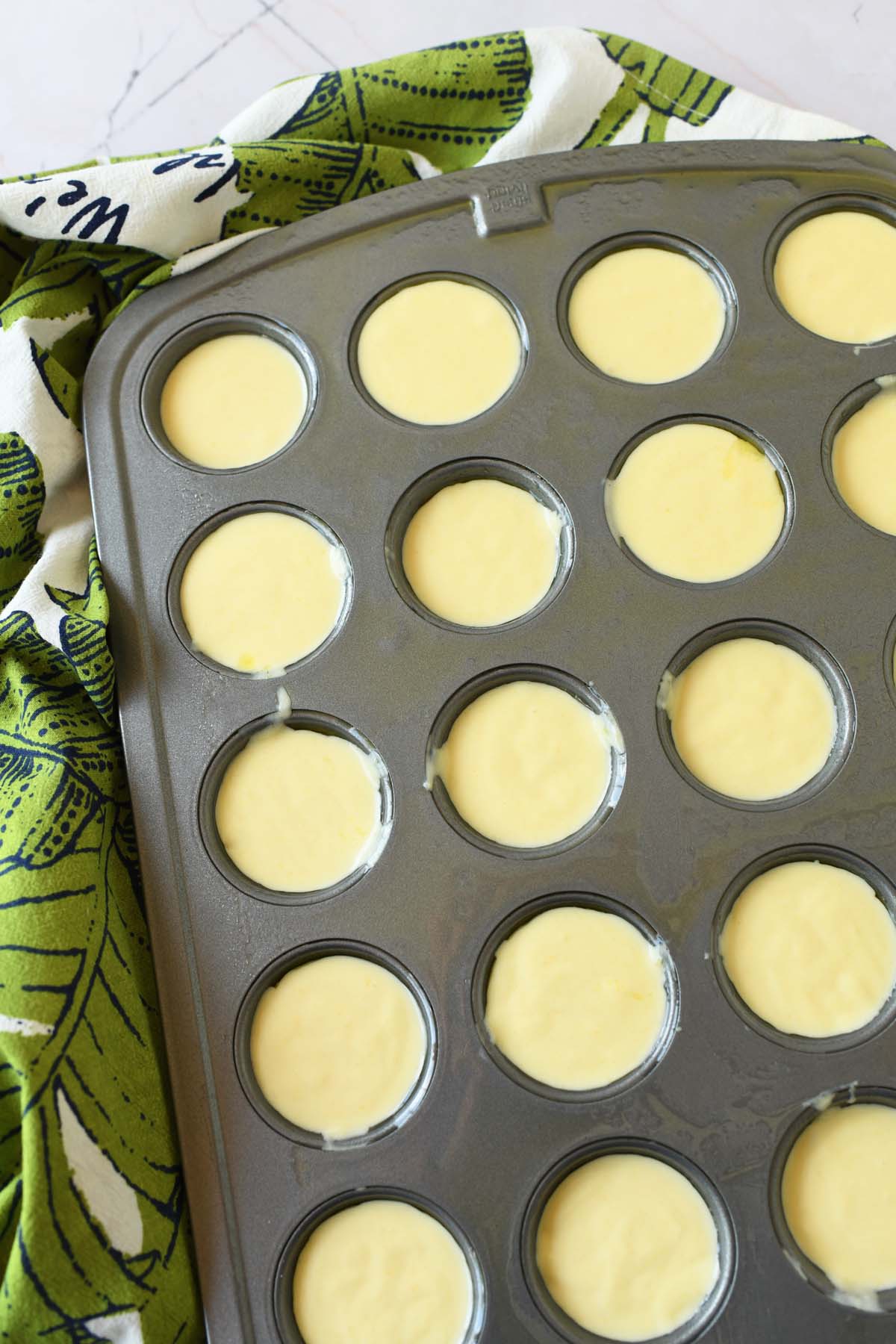Brazilian cheese bread batter inside a muffin tin.